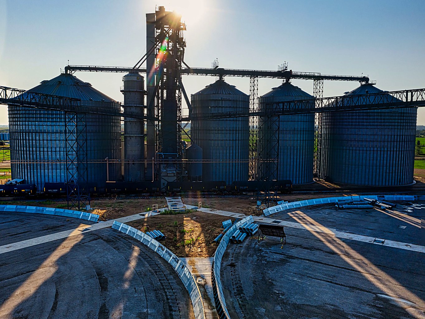Large corrugated steel grain silo terminal with bucket elevator and conveying gantries